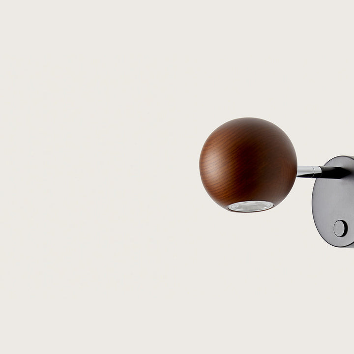 Side view of Lita Wall Lamp walnut wood globe and chrome swivel with base switch