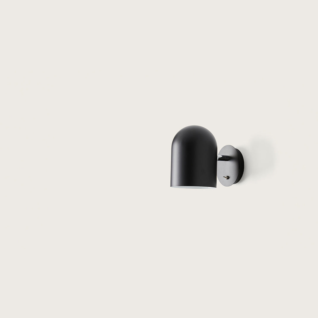 Luca Wall Lamp, black dome shade on a round wall plate with toggle switch, unlit, by Aromas del Campo
