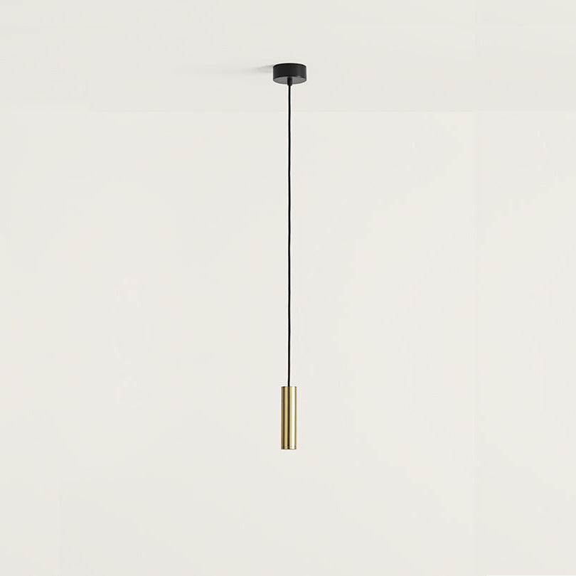 Maru Pendant Lamp, slim brass cylinder on a black cord with black ceiling canopy, unlit, by Aromas del Campo