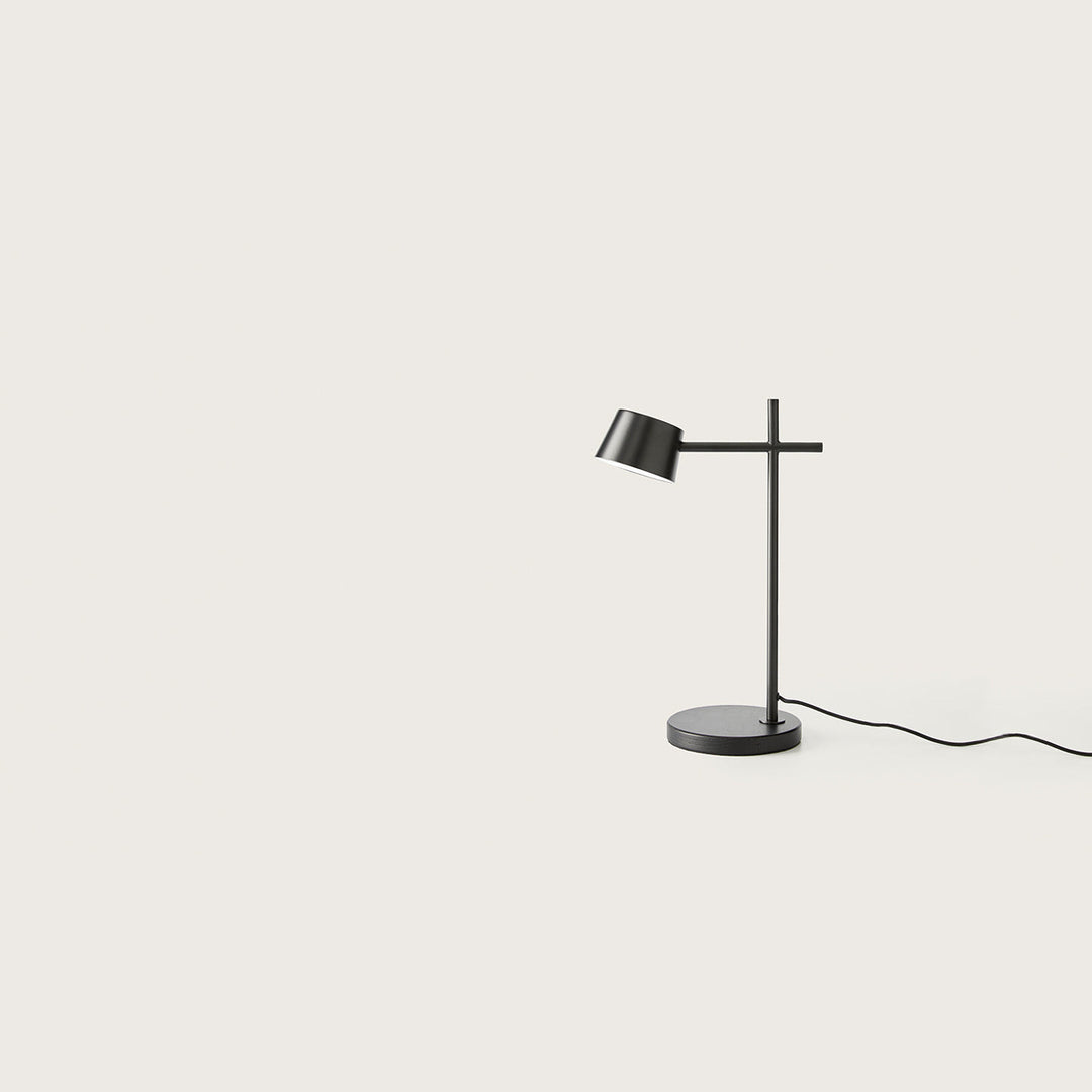Nera Table Lamp in matt black with angled drum shade, cross-bar stem and round base, unlit, by Aromas del Campo