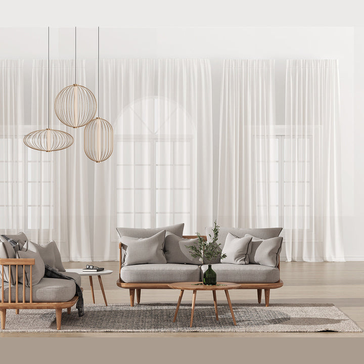Pepo Pendant Lamp, Medium (Ø23.8 in), group in gold wire above a grey sofa and wooden coffee table by sheer curtains