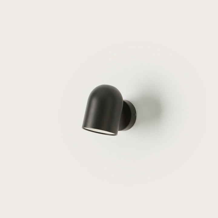 Pipe Wall Lamp, rounded matt black steel spotlight on a disc wall mount, by Aromas del Campo