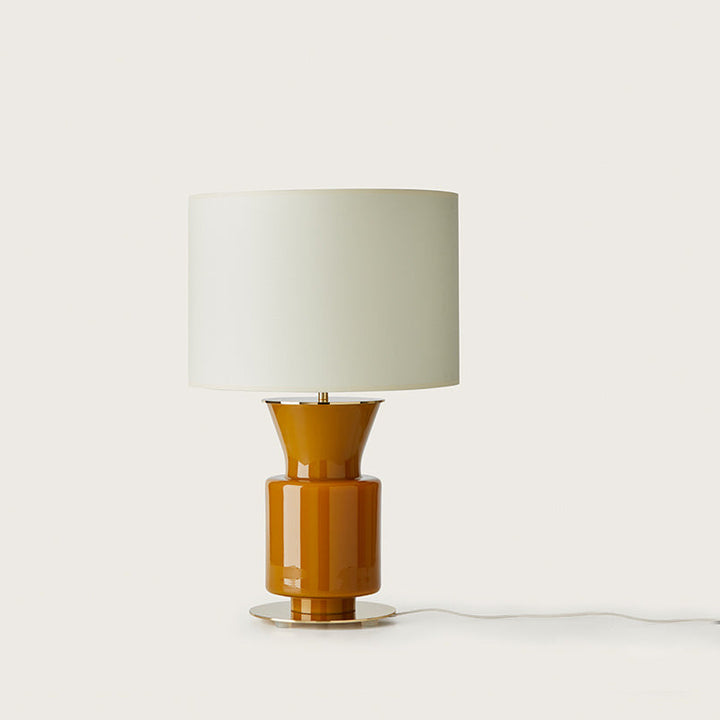 Ponn Table Lamp, glossy amber glass base on a brass disc with white drum shade, by Aromas del Campo
