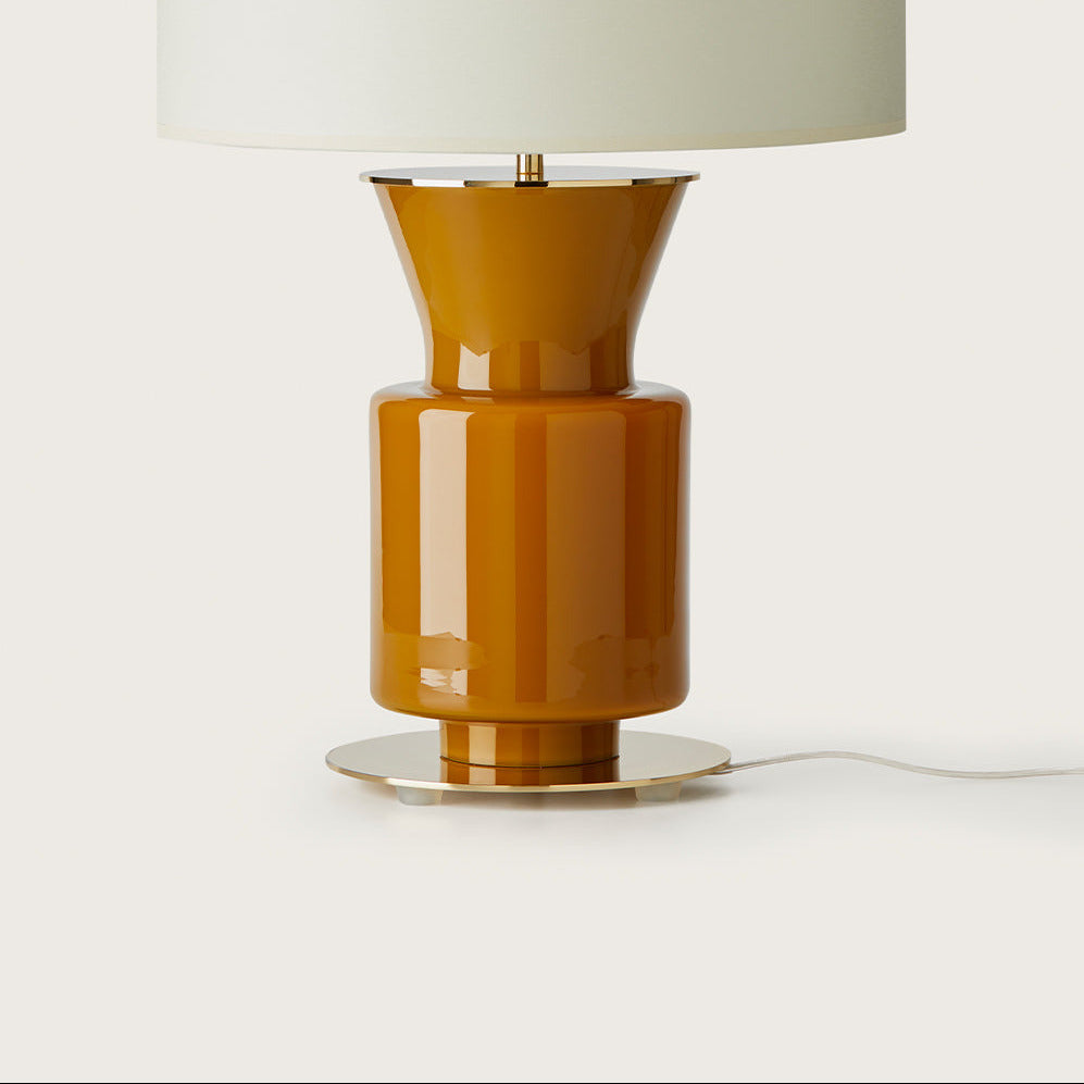 Ponn Table Lamp close-up of the amber glass body, brass foot and underside of the shade