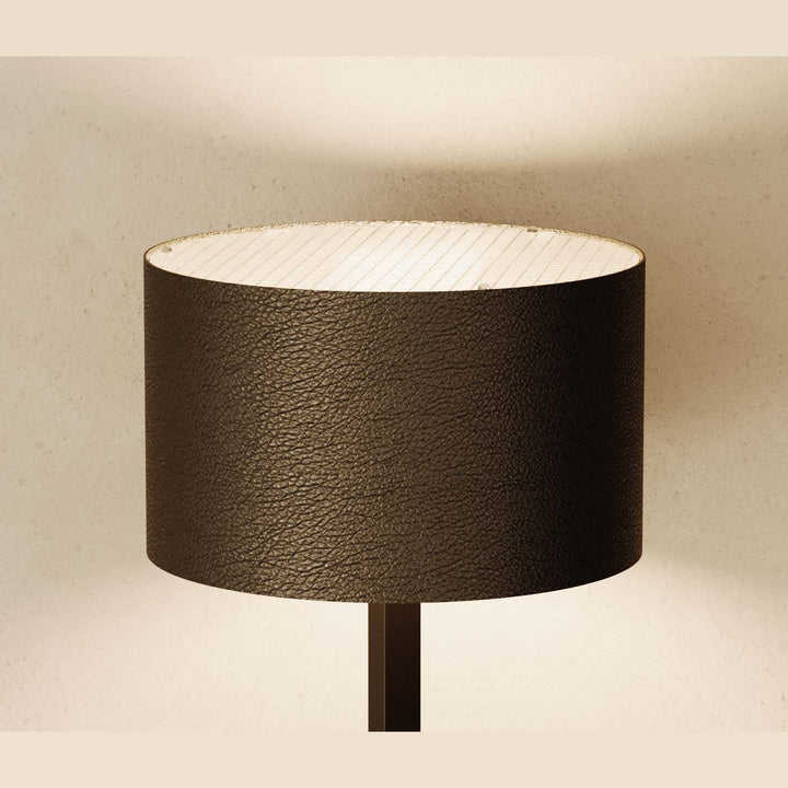 Rems Floor Lamp close-up of the textured dark brown leather shade, lit from inside
