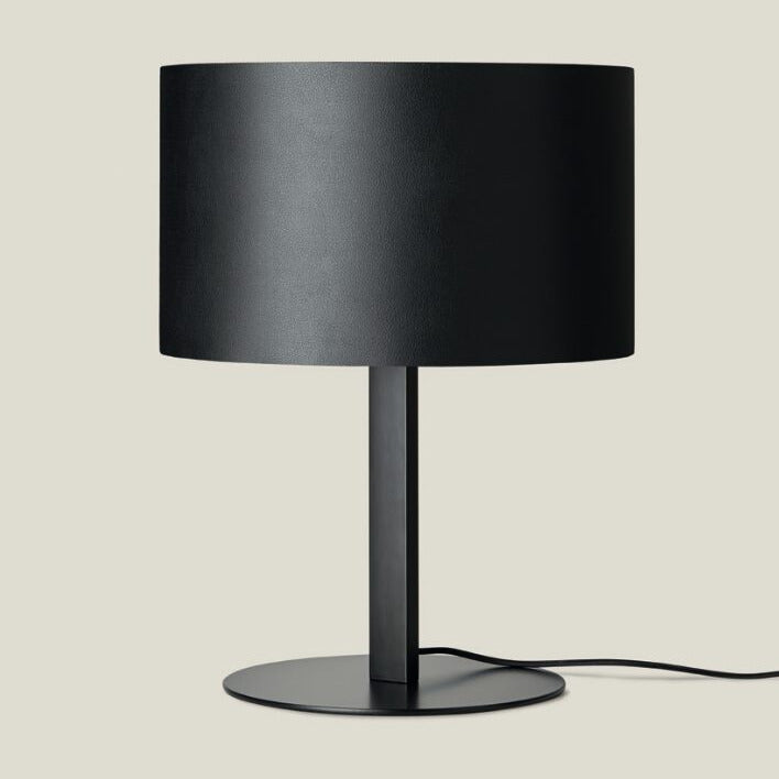 Black leather drum shade on a matt black stem and disc base with black cord