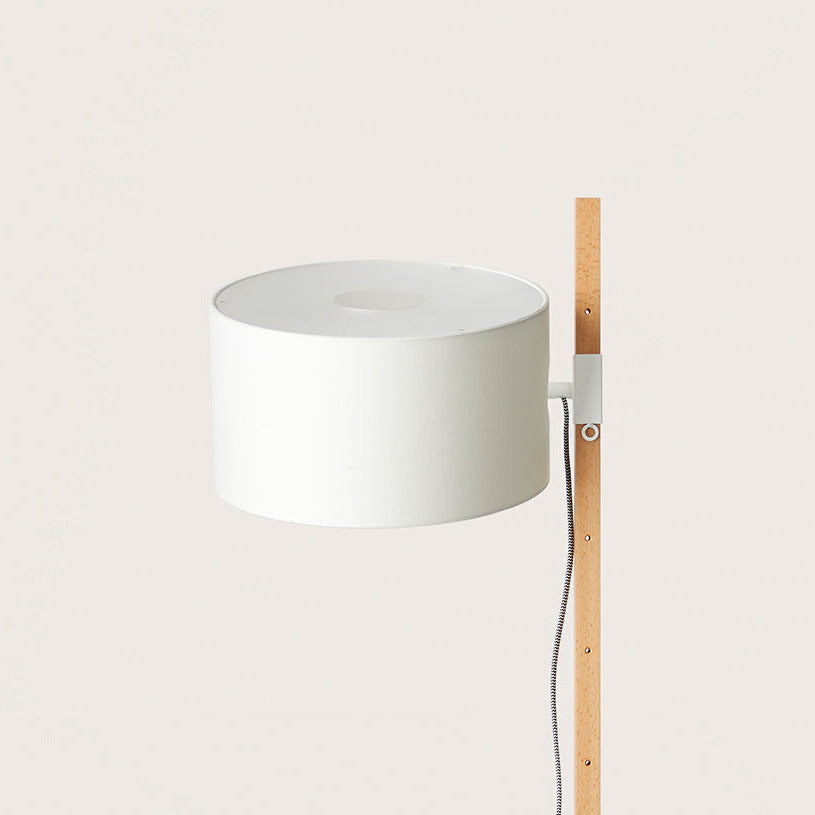 Close-up of Riu Floor Lamp white drum shade and adjustable bracket on the beech pole