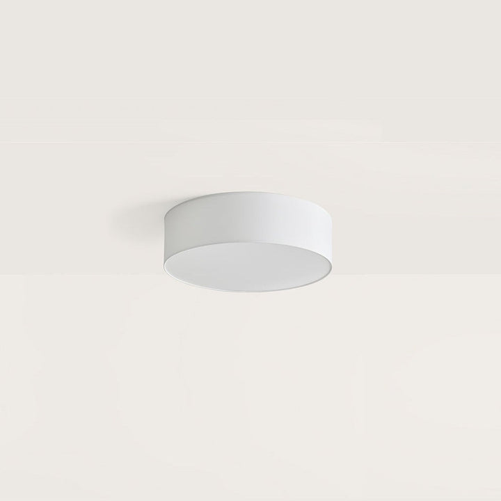 Tamb Ceiling Lamp, round, round white fabric ceiling light, unlit, mounted flush to a pale ceiling, by Aromas del Campo