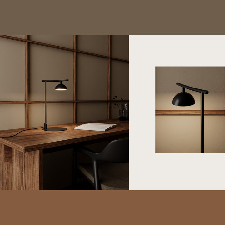 Tana Table Lamp lit on a wooden desk with a black chair, with a close-up of the glowing dome shade