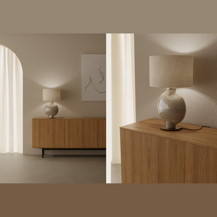 Tilla Table Lamp lit on a wooden sideboard in a neutral room, shown wide and close up