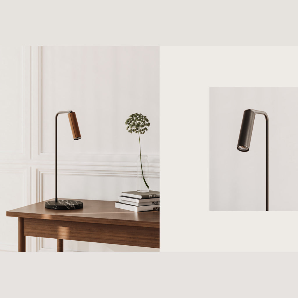Tura Table Lamp with orange leather head on a walnut desk beside books and a flower, plus a black leather detail