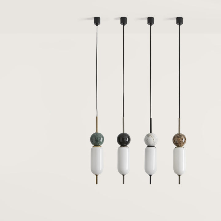 Four pendant lights with spherical decorative elements on a white background