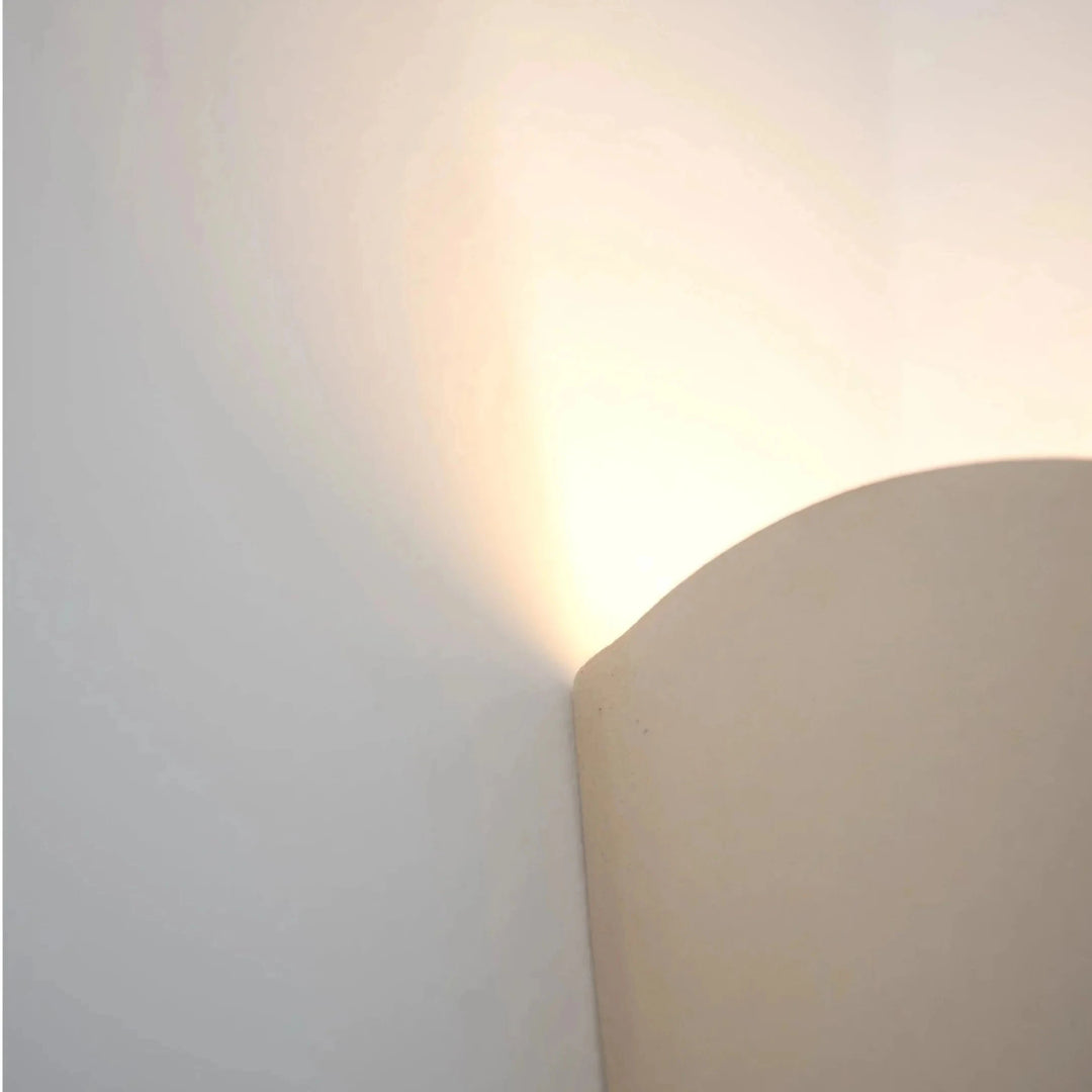 Still Lines Ceramic Wall Sconce — close-up detail of the top edge and upward light wash