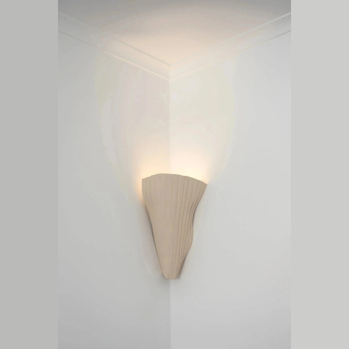 Tenderness Ceramic Wall Sconce — Corner mount, White Stoneware, installed in a room corner, illuminated