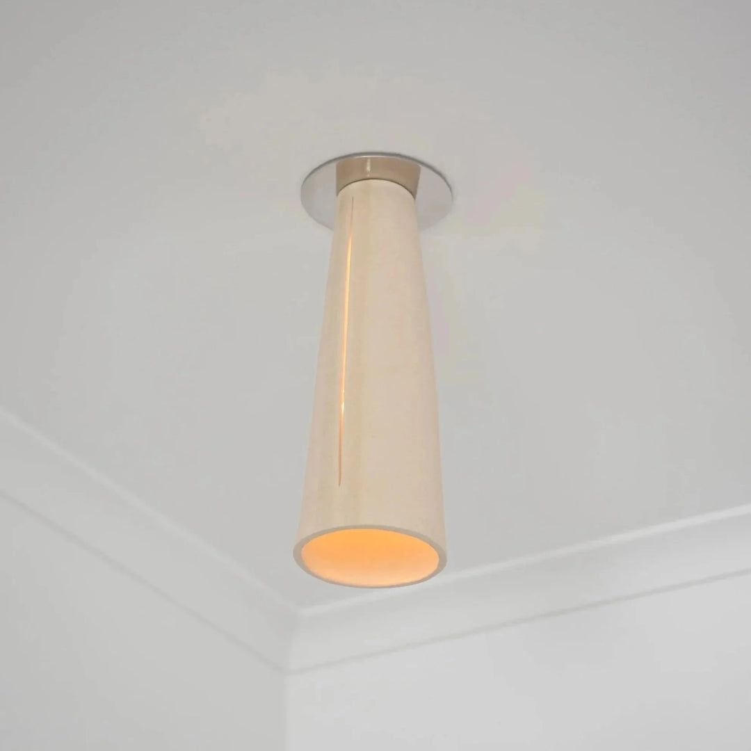 Interstice Ceramic & Steel Ceiling Light — White Stoneware, mounted near a ceiling corner, illuminated