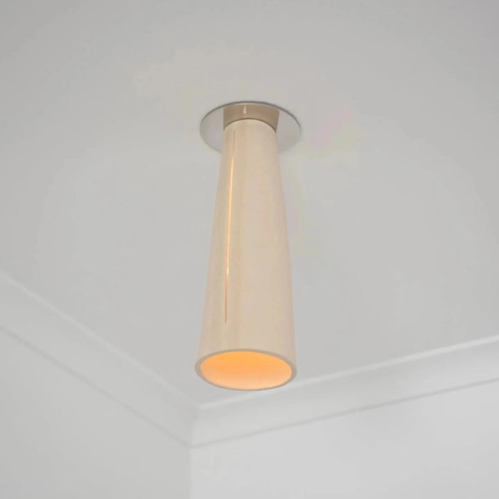 Interstice Ceramic &amp; Steel Ceiling Light — White Stoneware, mounted near a ceiling corner, illuminated