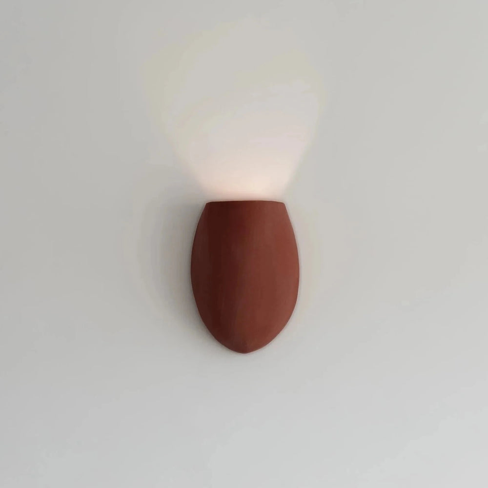Sanctuary I Ceramic Wall Sconce — Crimson, full front view illuminated on the wall