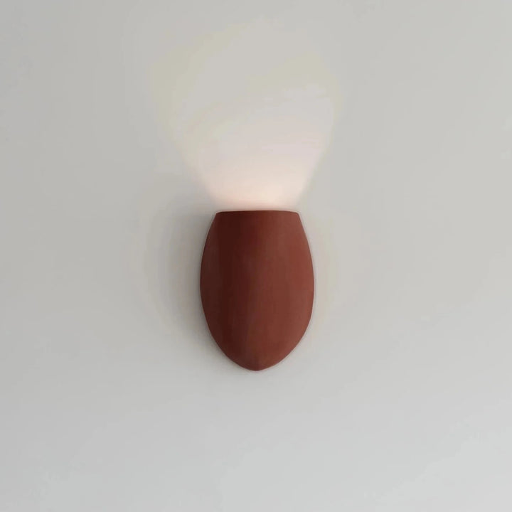 Sanctuary I Ceramic Wall Sconce — Crimson, full front view illuminated on the wall