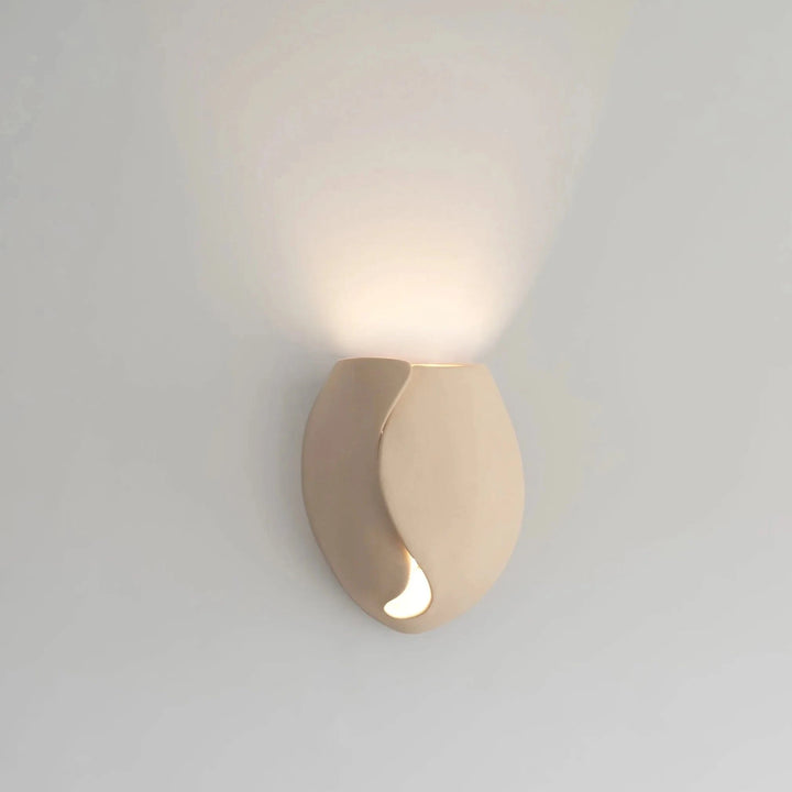 Sanctuary II Ceramic Wall Sconce — White Stoneware, full front view illuminated on the wall