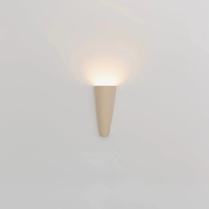 Still Lines Ceramic Wall Sconce — sand matte finish, full front view illuminated on the wall