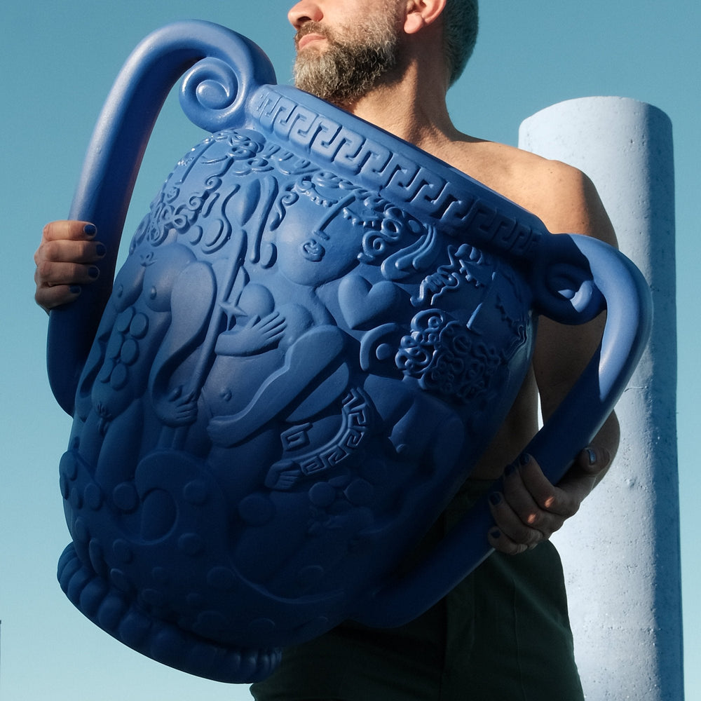 Seletti Magna Graecia Terracotta Amphora Vase Blue, a man carrying the blue amphora on his shoulder