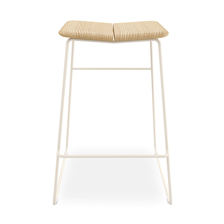 Woven rattan bar stool with minimalist white metal frame, designer home furnishing