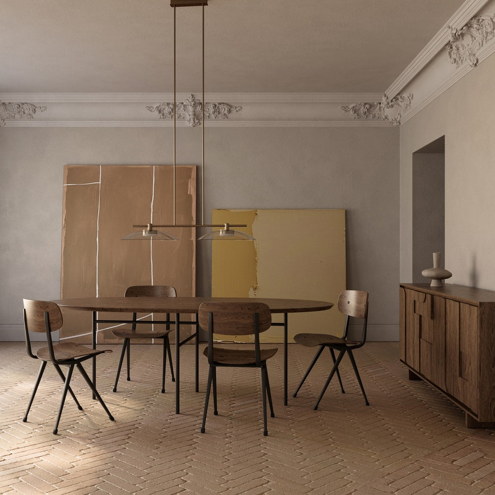 Betty Linear Pendant Linear Pendant over an oval wood dining table with bentwood chairs in a room with ornate cornices