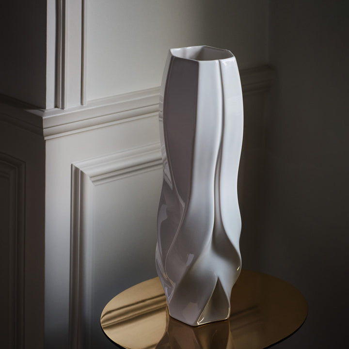 Braid Vase — white Tall vase on a round brass side table in a dark paneled room