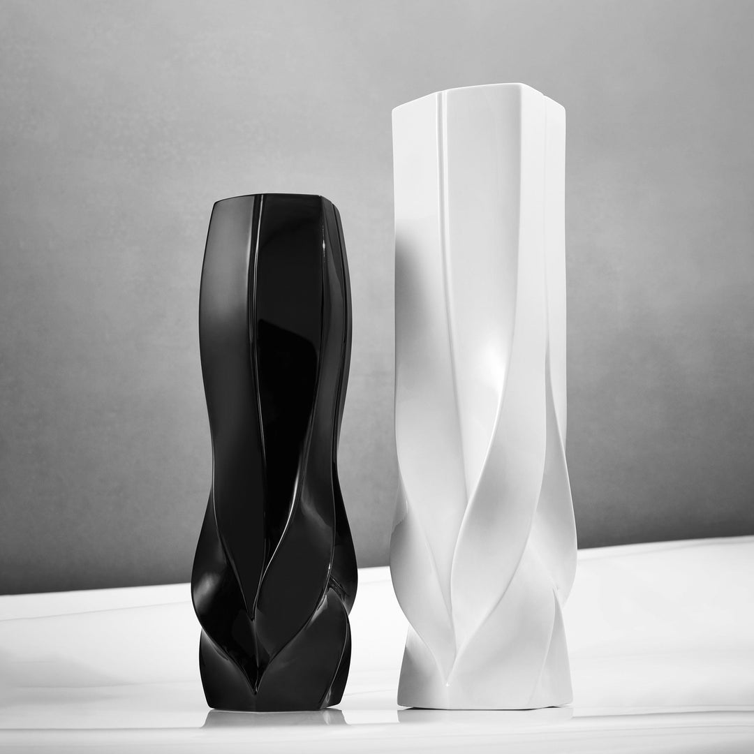 Braid Vase — black Waist vase beside a white Tall vase on a light surface against a gray wall