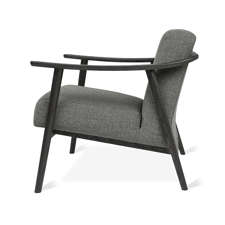 Elegant gray upholstered armchair with dark wood frame, modern designer furniture