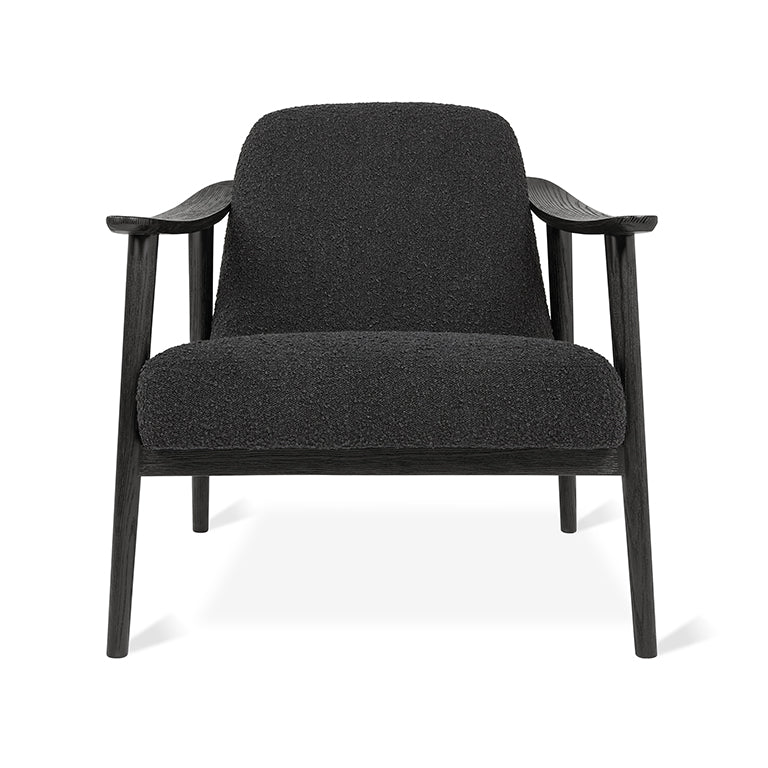 Black bouclé armchair with dark wood frame, modern designer furniture