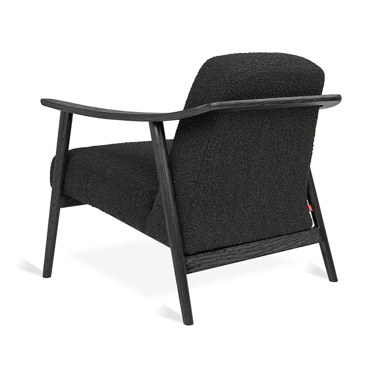 Black bouclé armchair with dark oak frame, mid-century modern design