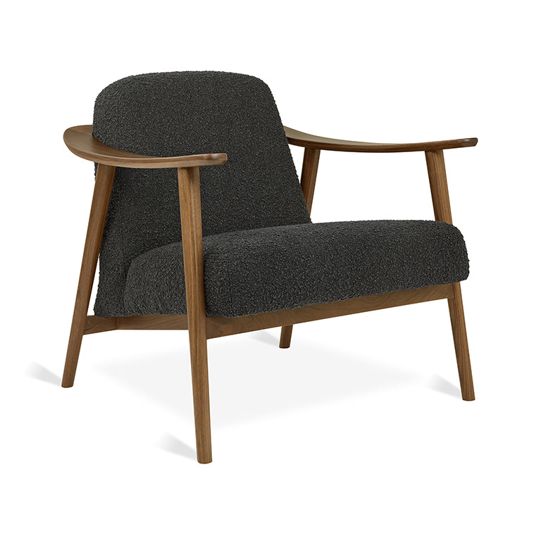 Mid-century modern armchair with dark bouclé upholstery and walnut wood frame