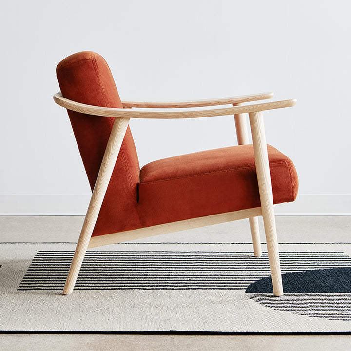 Rust velvet armchair with light oak frame, modern designer furniture