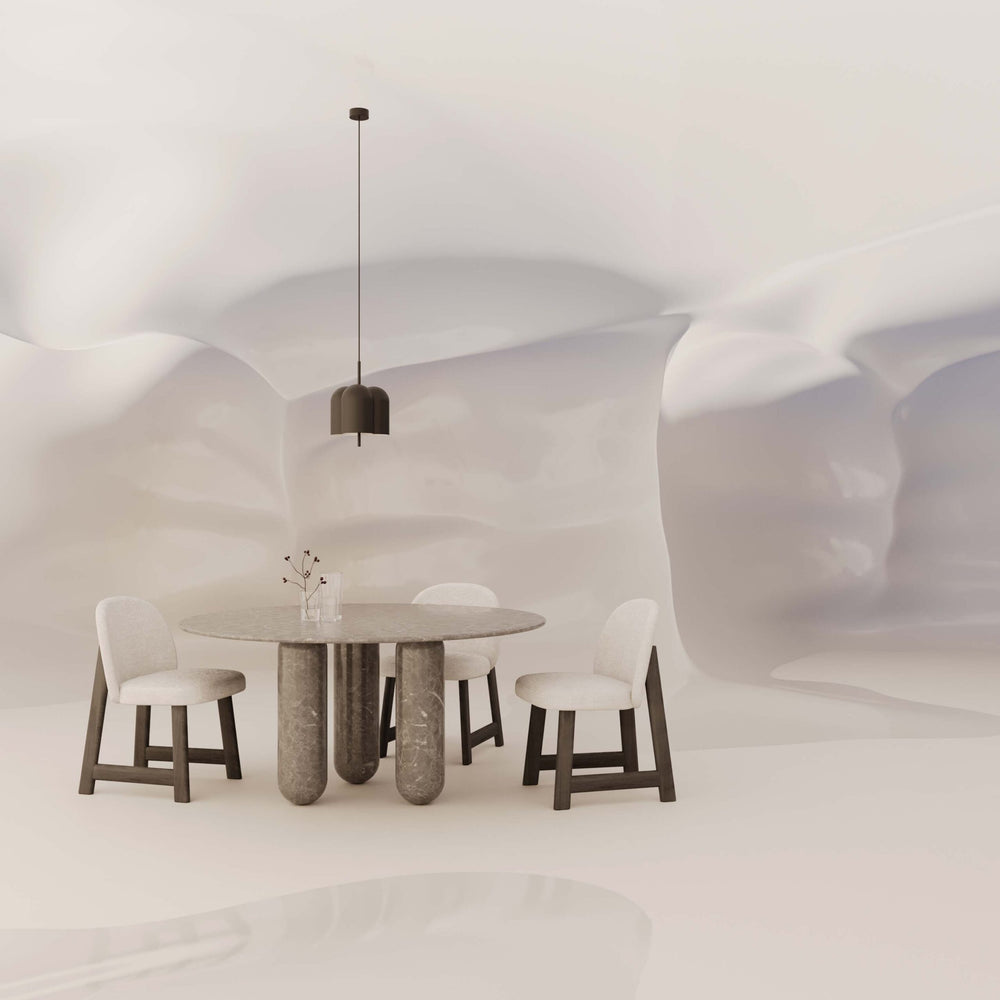 Oket Pendant Lamp above a marble dining table and white chairs in a sculpted white room