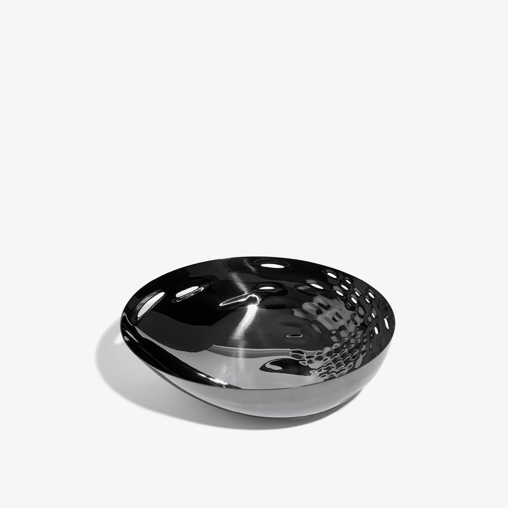 Cell Bowl — small black bowl, three-quarter view of the cell-pattern interior on a white background