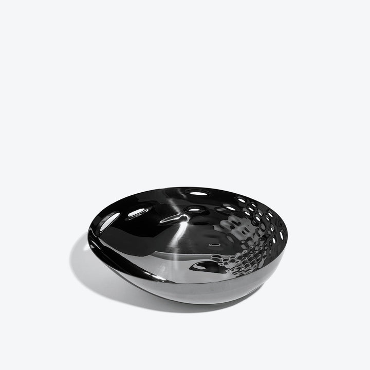 Cell Bowl — small black bowl, three-quarter view of the cell-pattern interior on a white background