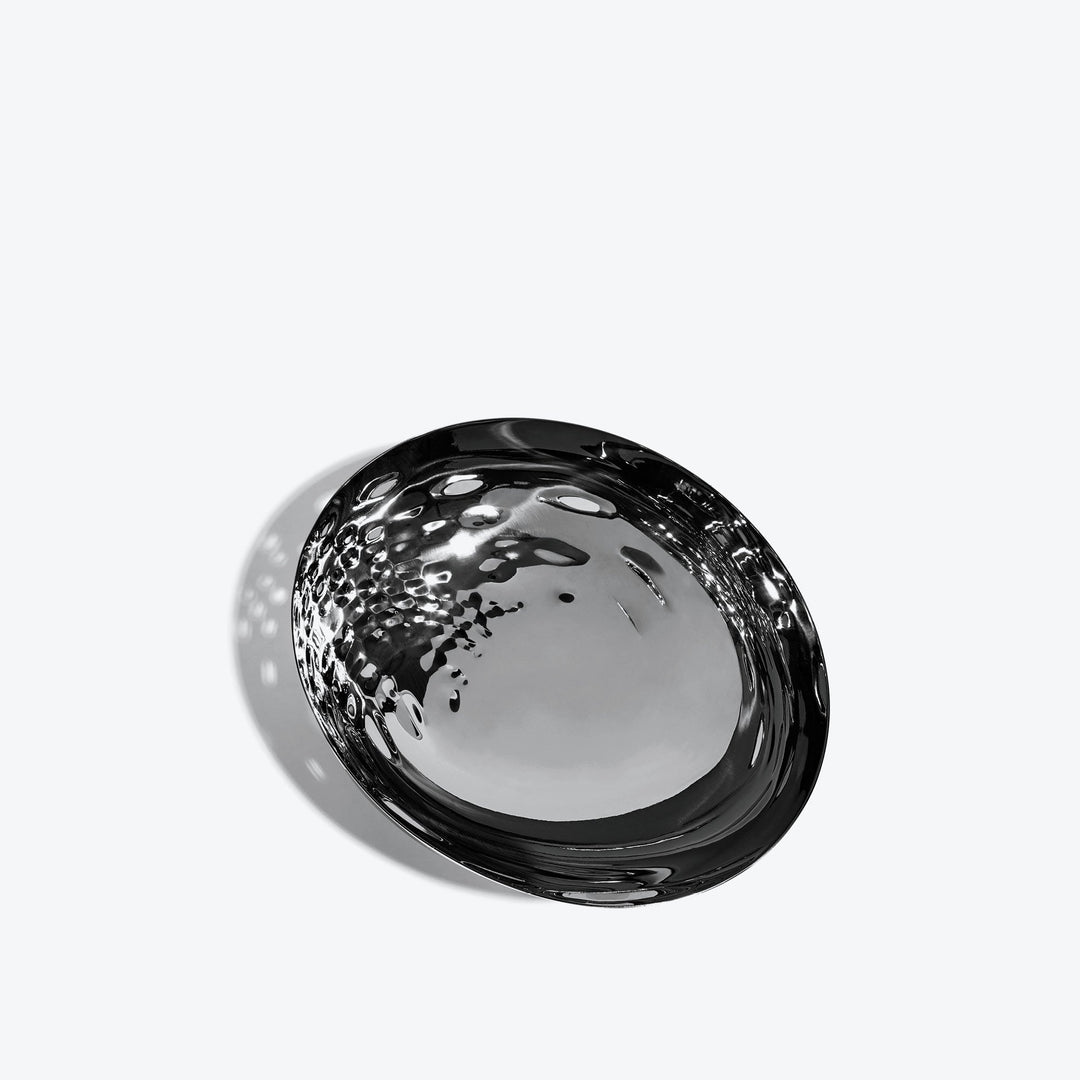 Cell Bowl — small black bowl tilted to show the dimpled cell interior, on a white background