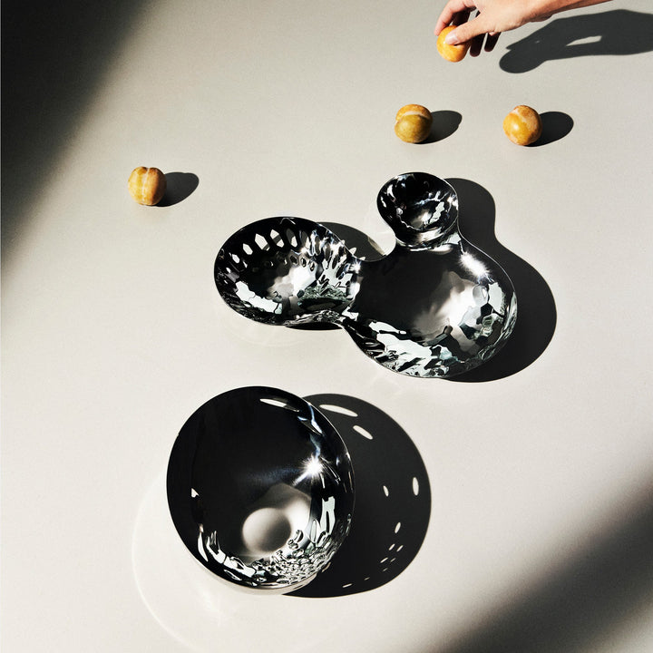 Cell Bowl — polished small and large bowls in sunlight with apricots on a pale table, top-down lifestyle view