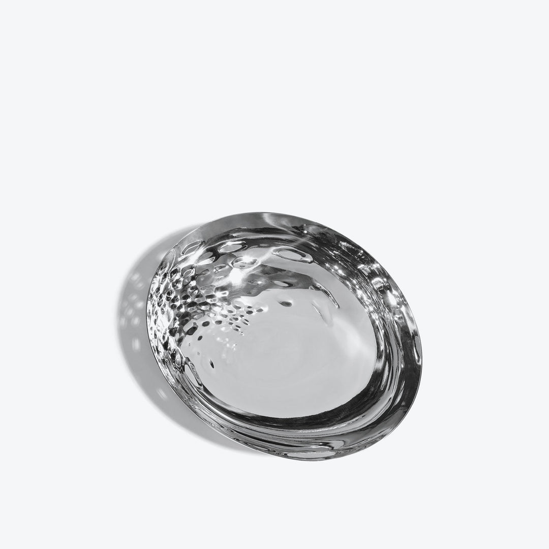 Cell Bowl — small silver bowl tilted to show the dimpled cell interior, on a white background