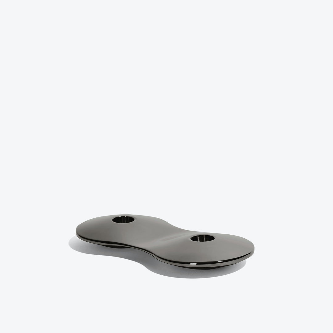 Cell Candle Holder — small black two-candle piece, low side view on a white background