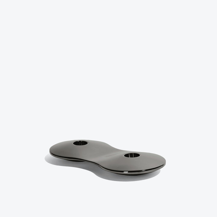 Cell Candle Holder — small black two-candle piece, low side view on a white background