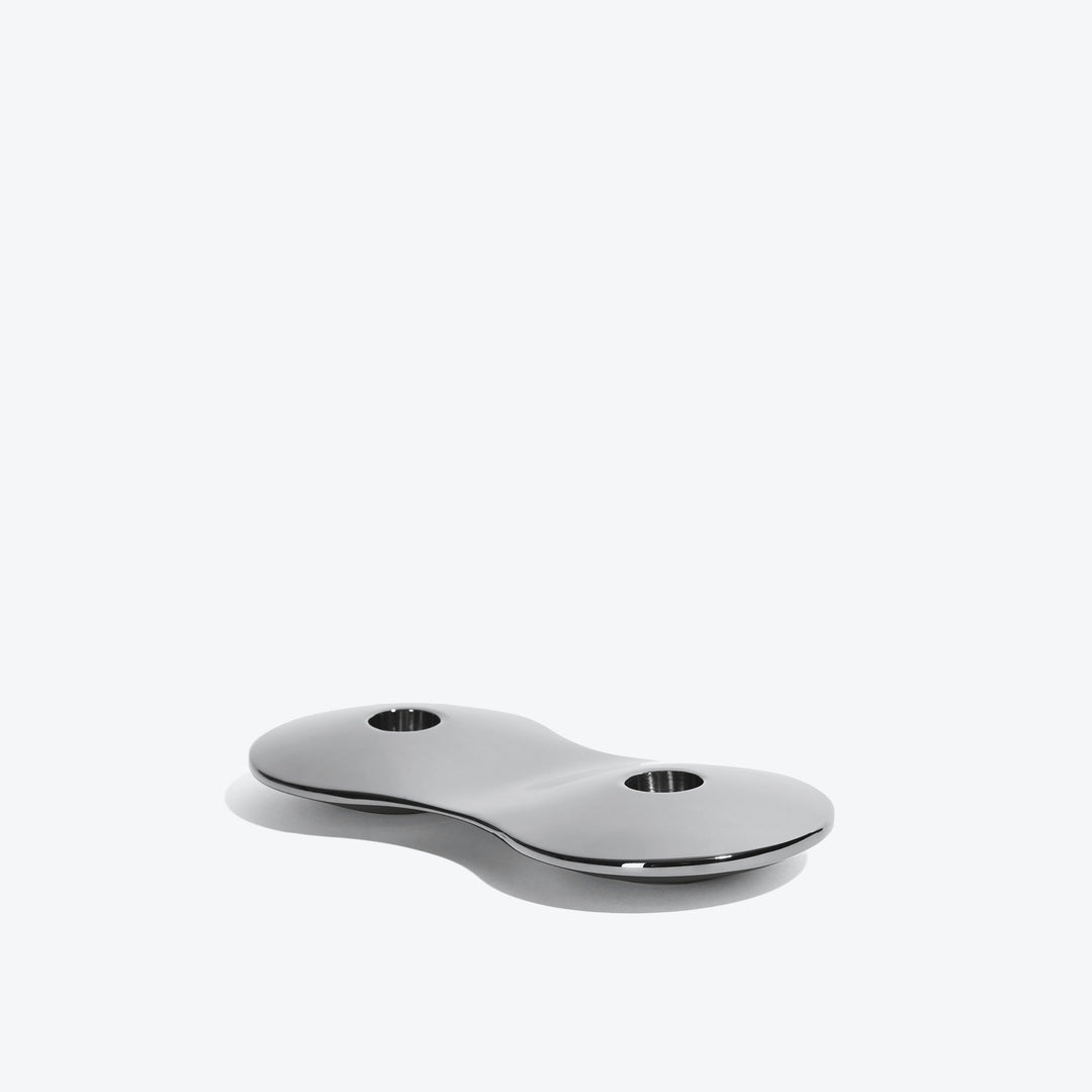 Cell Candle Holder — small silver two-candle piece, low side view on a white background
