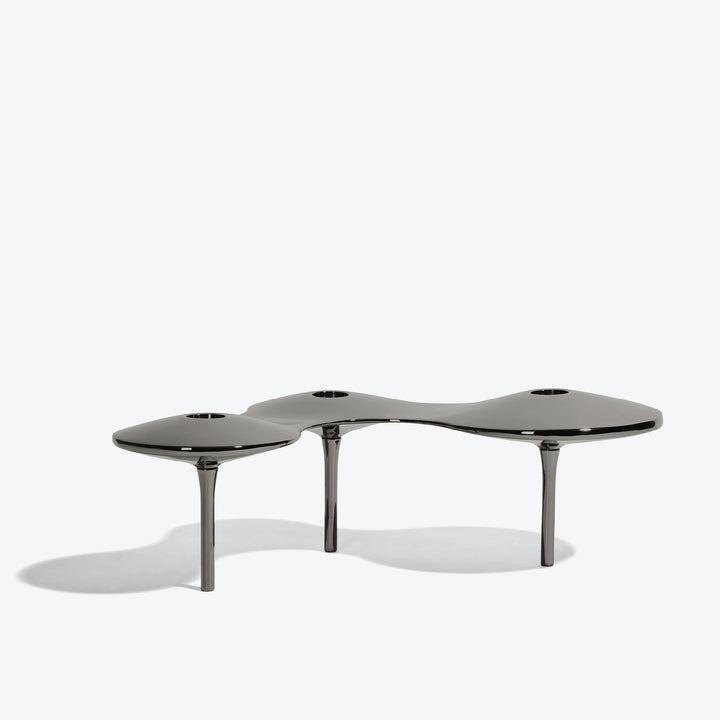 Cell Candle Holder — large black three-candle piece on tall legs, low side view on white