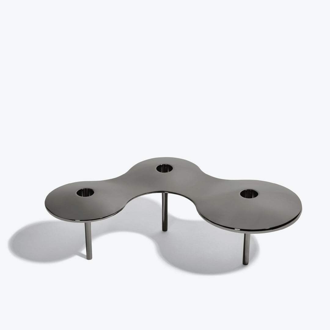 Cell Candle Holder — large black three-candle piece on tall legs, front three-quarter view