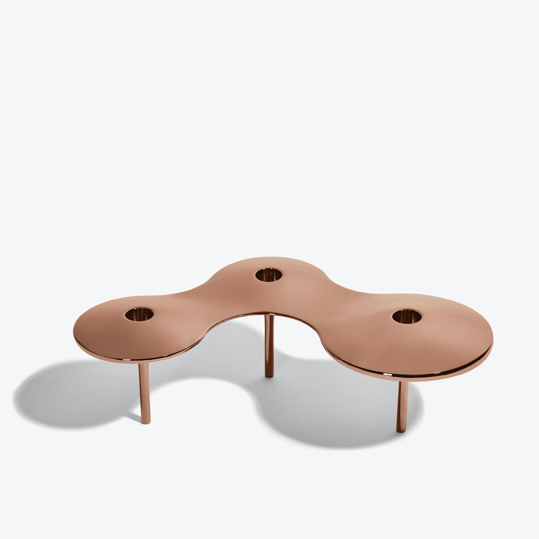 Cell Candle Holder — large rose gold three-candle piece on tall legs, front three-quarter view