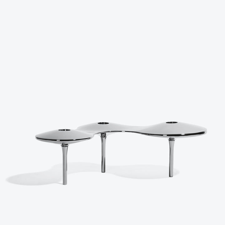 Cell Candle Holder — large silver three-candle piece on tall legs, low side view on white