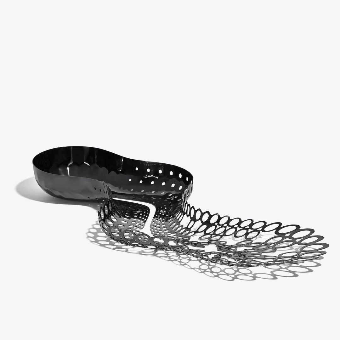 Cell Centerpiece — black stainless steel centerpiece, three-quarter view from the solid bowl end