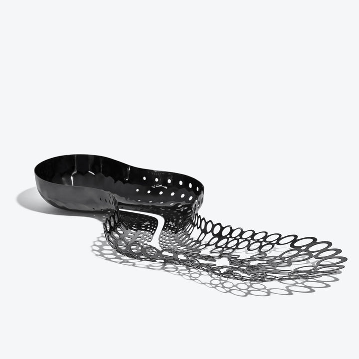 Cell Centerpiece — black stainless steel centerpiece, three-quarter view from the solid bowl end