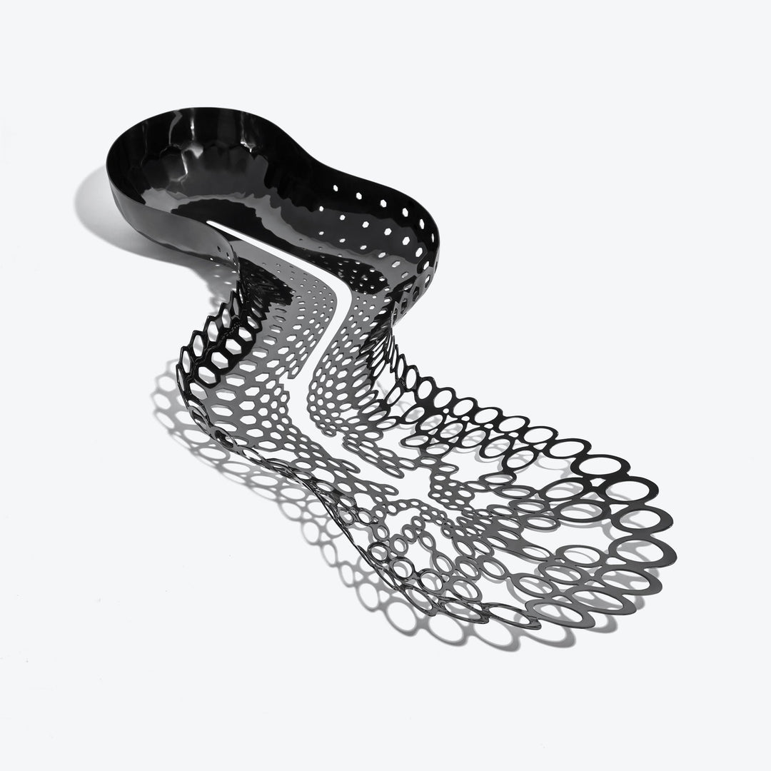 Cell Centerpiece — black stainless steel centerpiece seen from above, bowl tapering into open cells